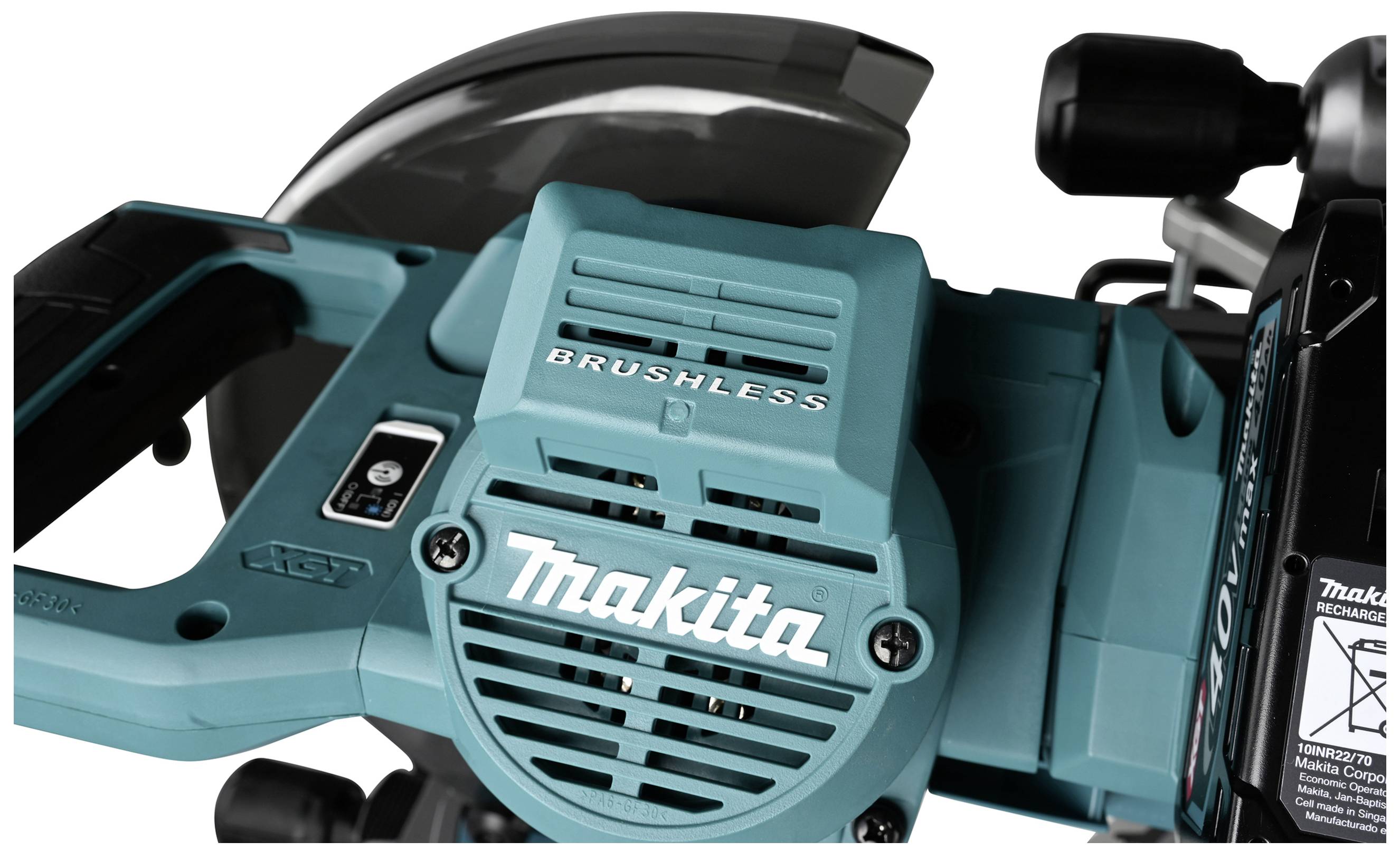'Battery-powered, brushless Makita saw in close-up, showing ventilation slots and brand name on the casing.'