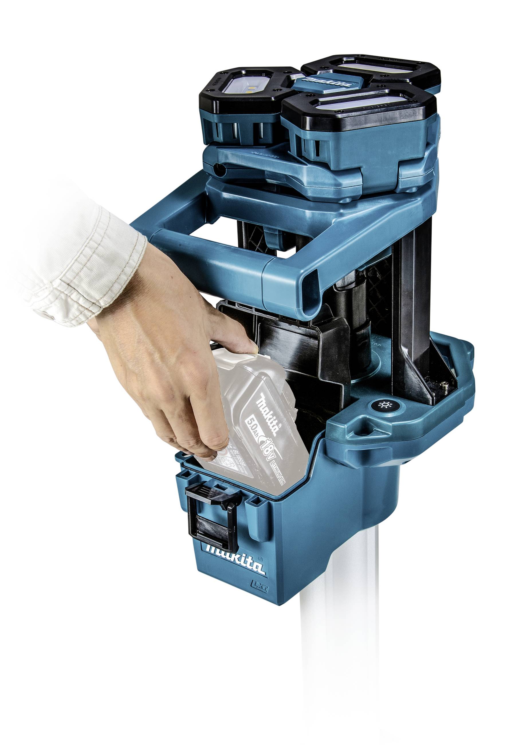 A person is inserting a battery into a blue device, likely a tool or charger. The device has two slots for batteries.