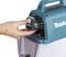 A hand is inserting a battery into a compact, portable, blue electric power tool.