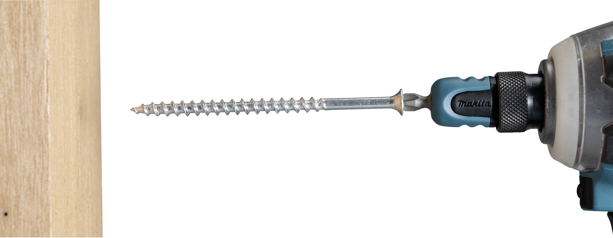 Cordless drill with a long screw, ready to be driven into a wooden board.