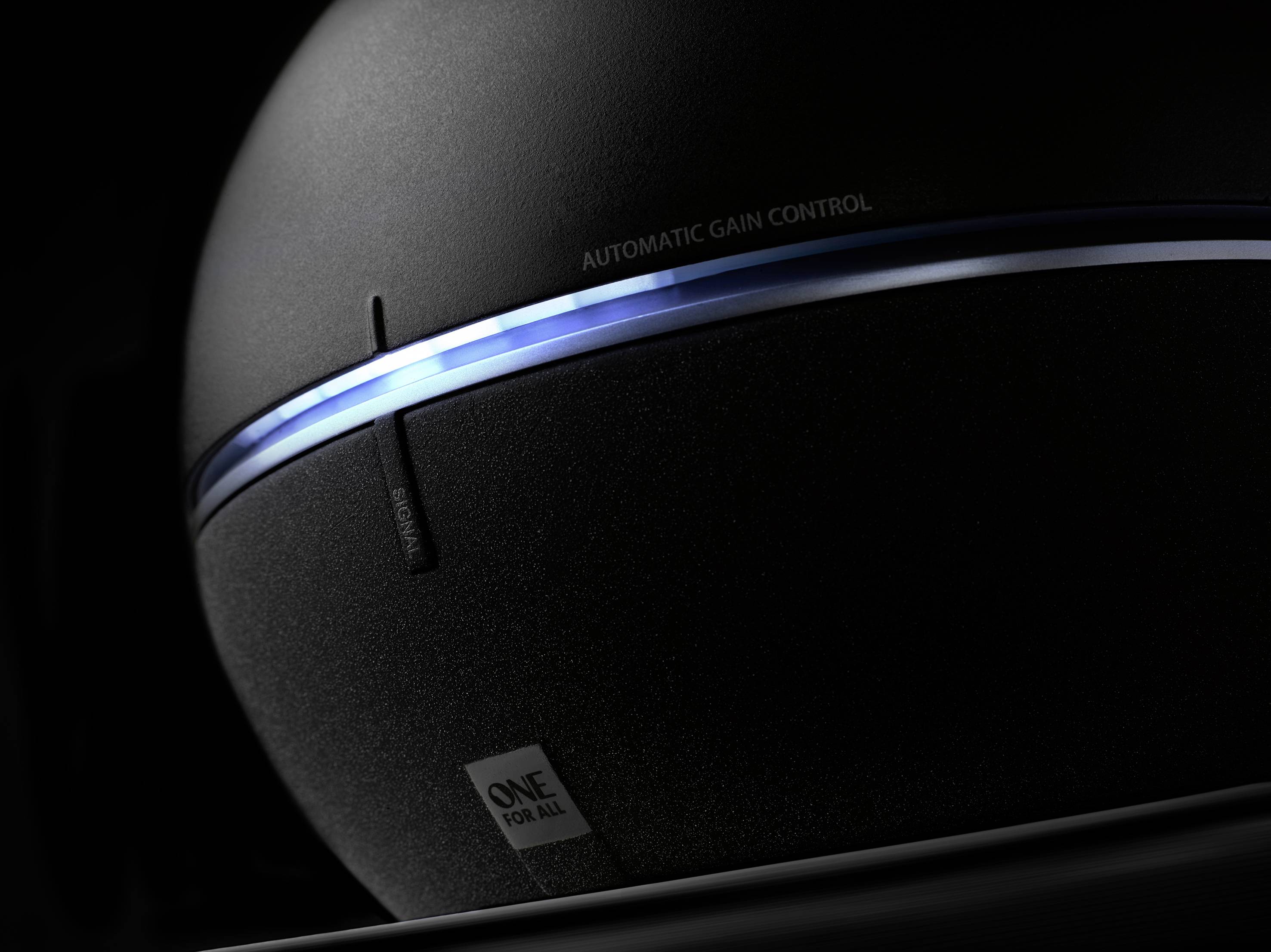 Black spherical device with a luminous blue line and the inscription 'Automatic Gain Control'. Underneath it says 'One For All'.
