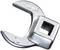 A silver socket attachment with a square opening for fixing to a torque wrench.