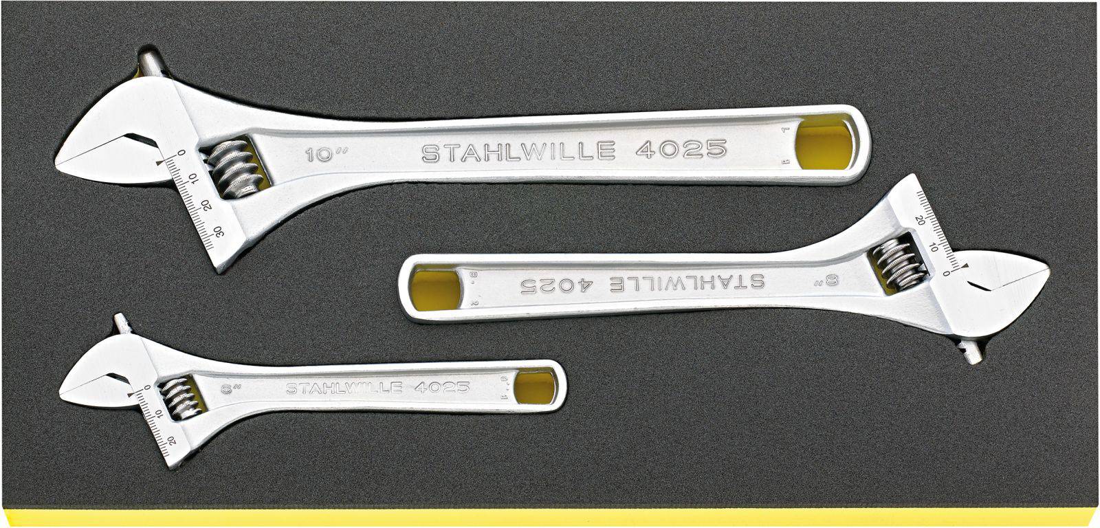 Three adjustable spanners of different sizes, manufactured by Stahlwille, are laid side by side on a dark surface.
