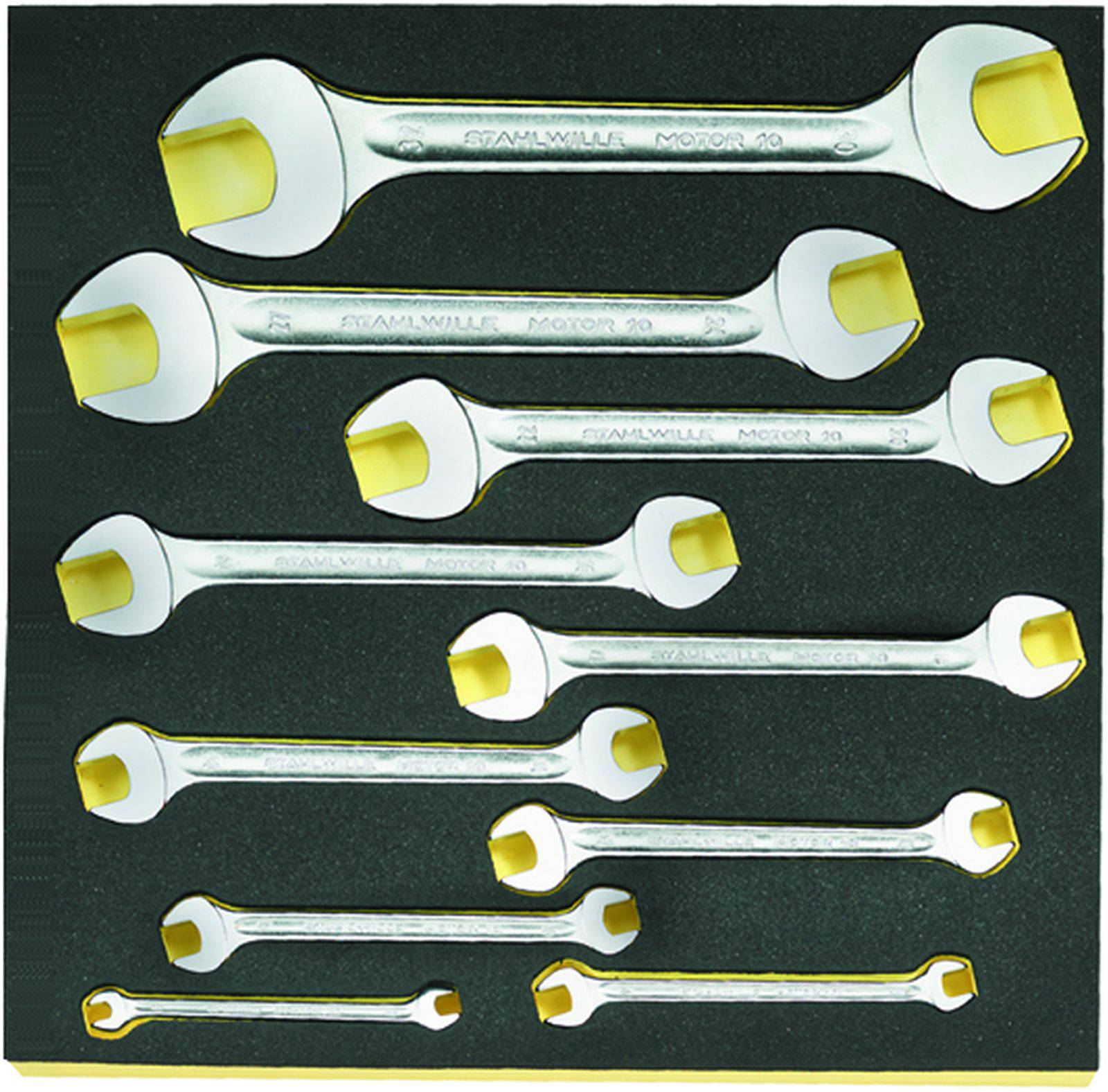 A collection of twelve open spanners in various sizes, arranged on a black surface.