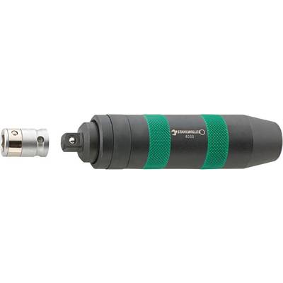 A torque wrench with a green handle lies next to a metal adapter.