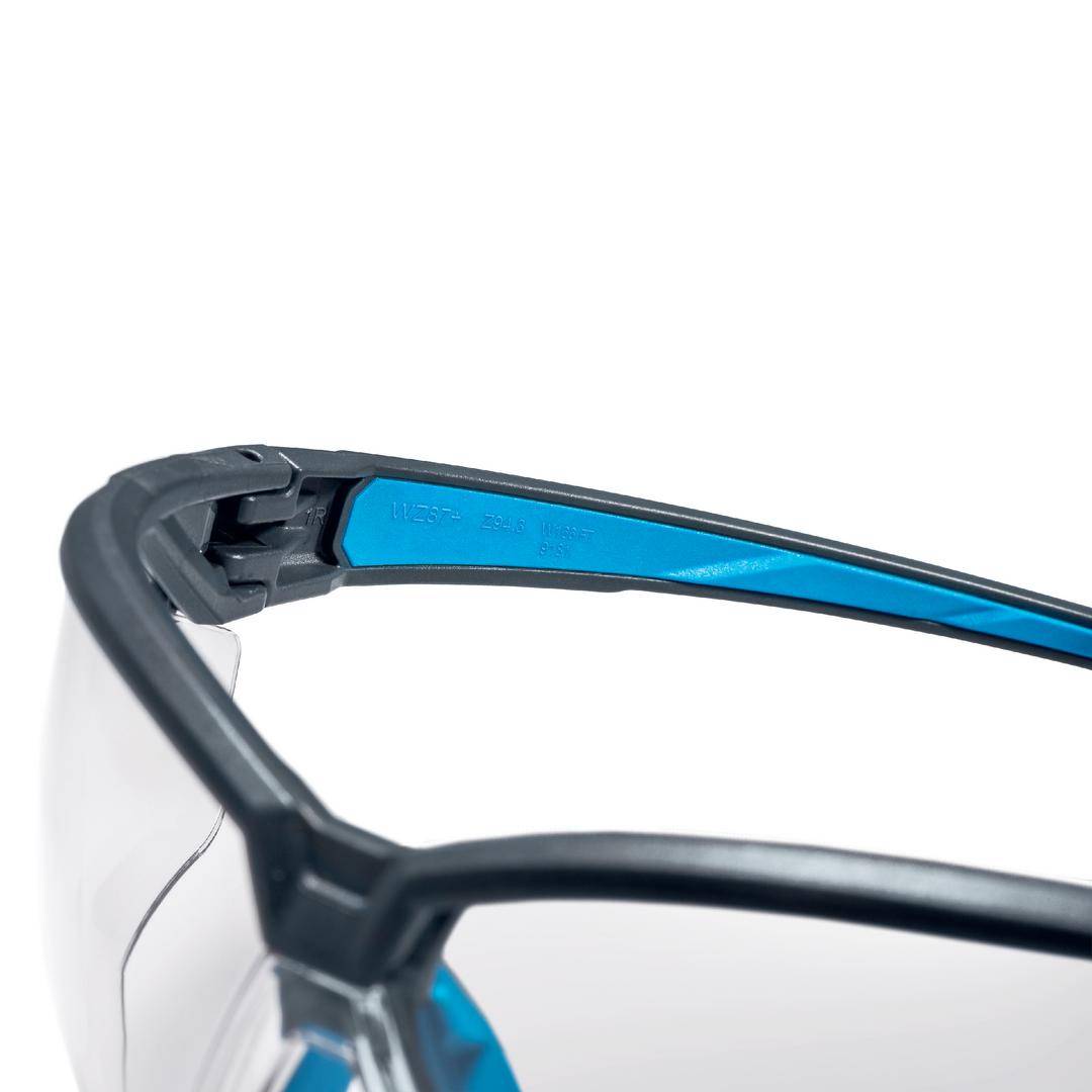 A close-up of a stylish pair of glasses with a black frame and vibrant blue interior design, showcasing modern elegance and style.