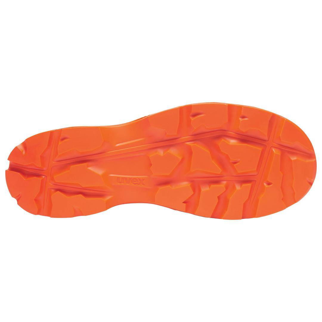 Shoe sole with an orange-coloured tread and grooves that provide good grip on uneven terrain.