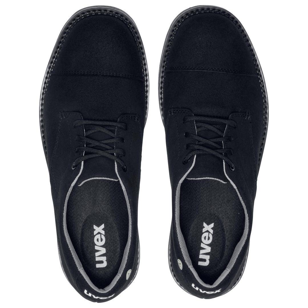 A pair of black Uvex shoes, viewed from above, with laces and a white seam along the sole.
