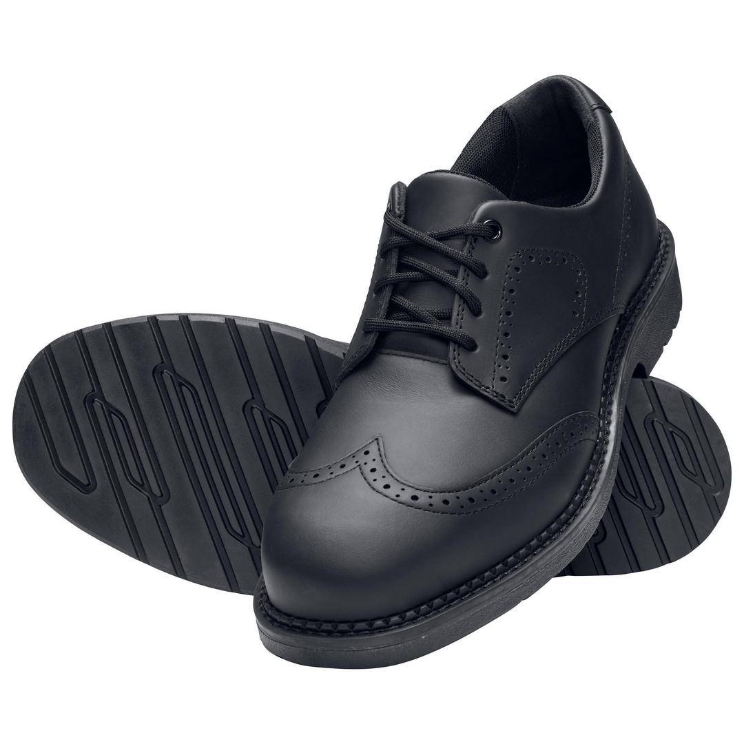 Black men's leather shoes with a brogue pattern. Showing a pair, with one shoe standing upright and the other displaying its sole.