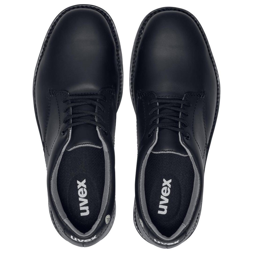 Black shoes photographed from above. The shoes have a smooth surface and bear the 'uvex' logo on the insole.