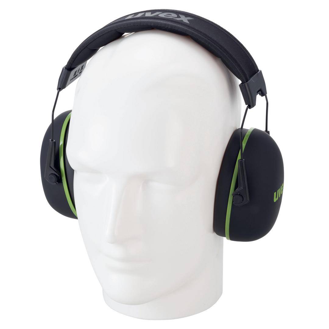 A white mannequin head is wearing black ear defenders with green accents and a padded headband, providing noise protection.