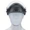 A black protective helmet with a transparent visor on a white model head. The helmet provides protection for the head and face.