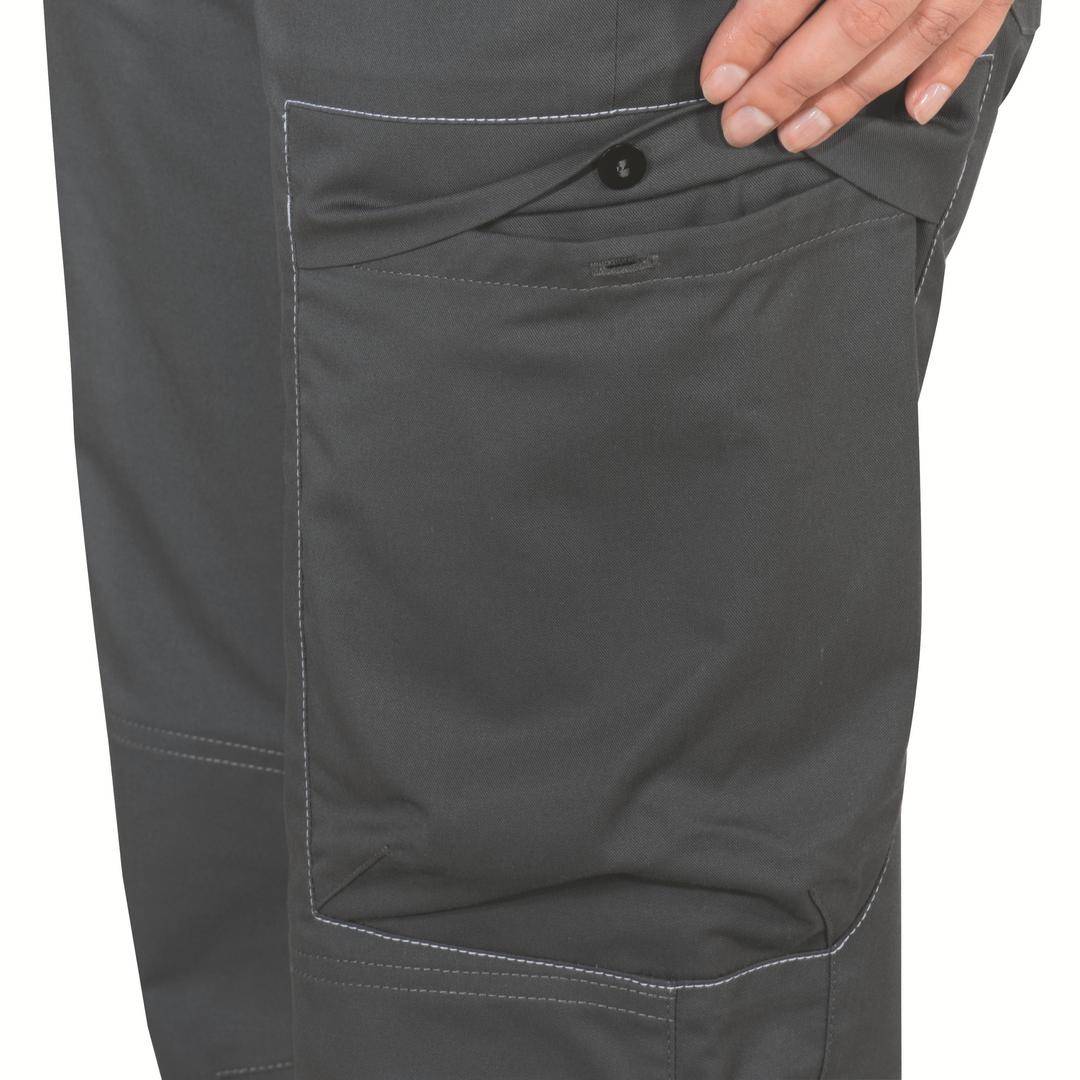Close-up of a hand reaching into the side pocket of a grey work trouser. The trousers have white stitching.