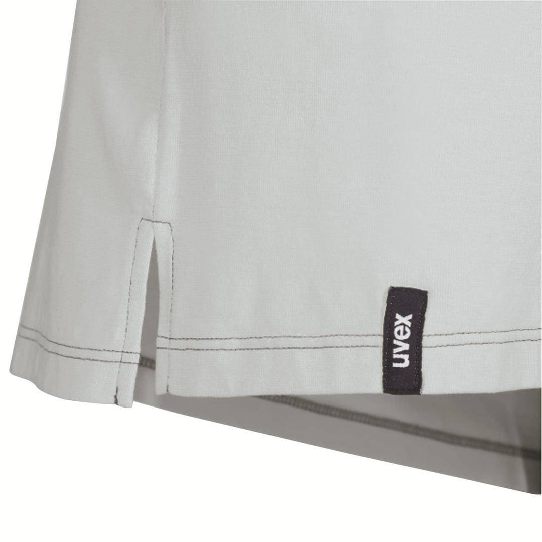 Lower section of a grey shirt with hemmed edges and a black 'uvex' label at the hem.