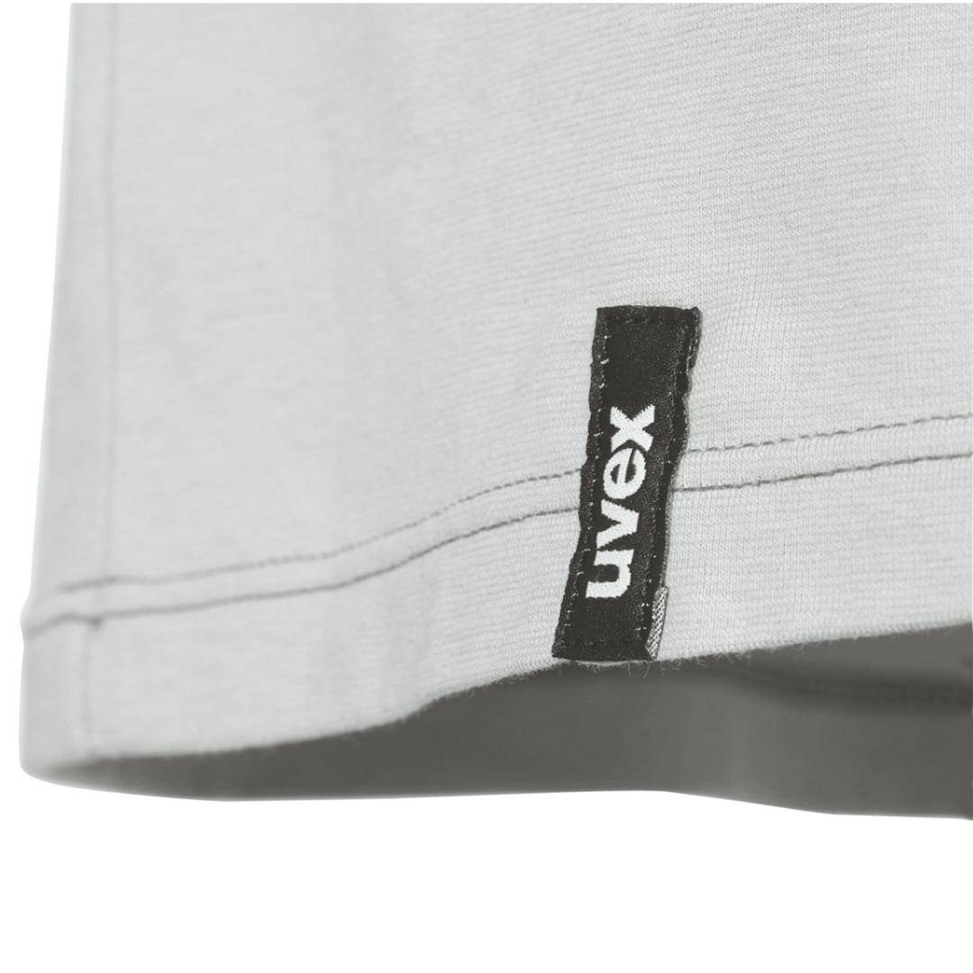 White t-shirt with 'uvex' label at the bottom edge, just visible above a black background.