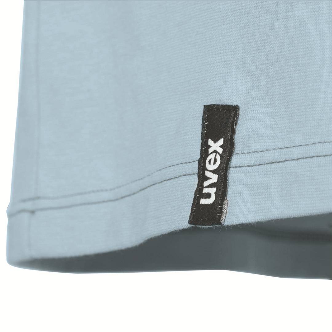 Close-up view of a grey garment with a black label reading 'uvex'.
