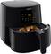 Black Philips air fryer with an open basket containing crispy-looking chicken thighs. Digital display shows 180 degrees.
