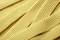 Close-up of folded, yellow, crinkled strips that look like dough or ribbon.