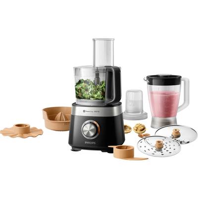 Kitchen food processor with accessories: mixer, citrus press, cutting attachments. Preparing a green salad mix, alongside a pink smoothie in the blender.