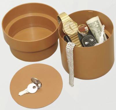 Brown container with a removable lid, filled with wristwatch, roll of coins, car keys and jewellery. Keys are lined up along the lid.