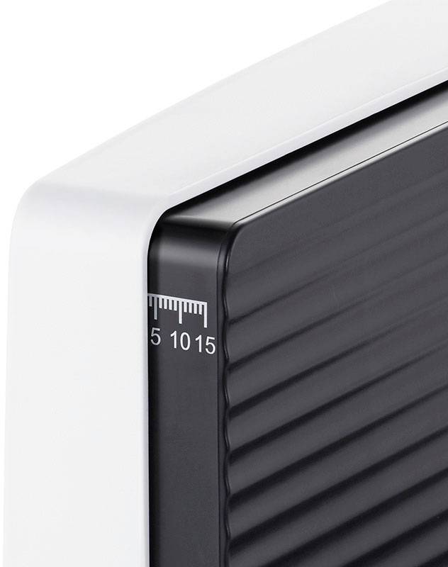 Close-up of a modern, white radiator with a black, ribbed design and a scale from 5 to 15 on the side.