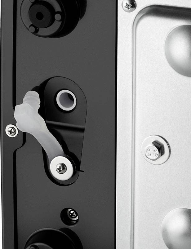 Close-up of a mechanical component made of metal and plastic with screws, a lever mechanism, and a black exterior surface.
