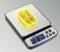 A digital scale shows a weight of 89 grams, with a yellow box containing yellow connectors placed on the scale.