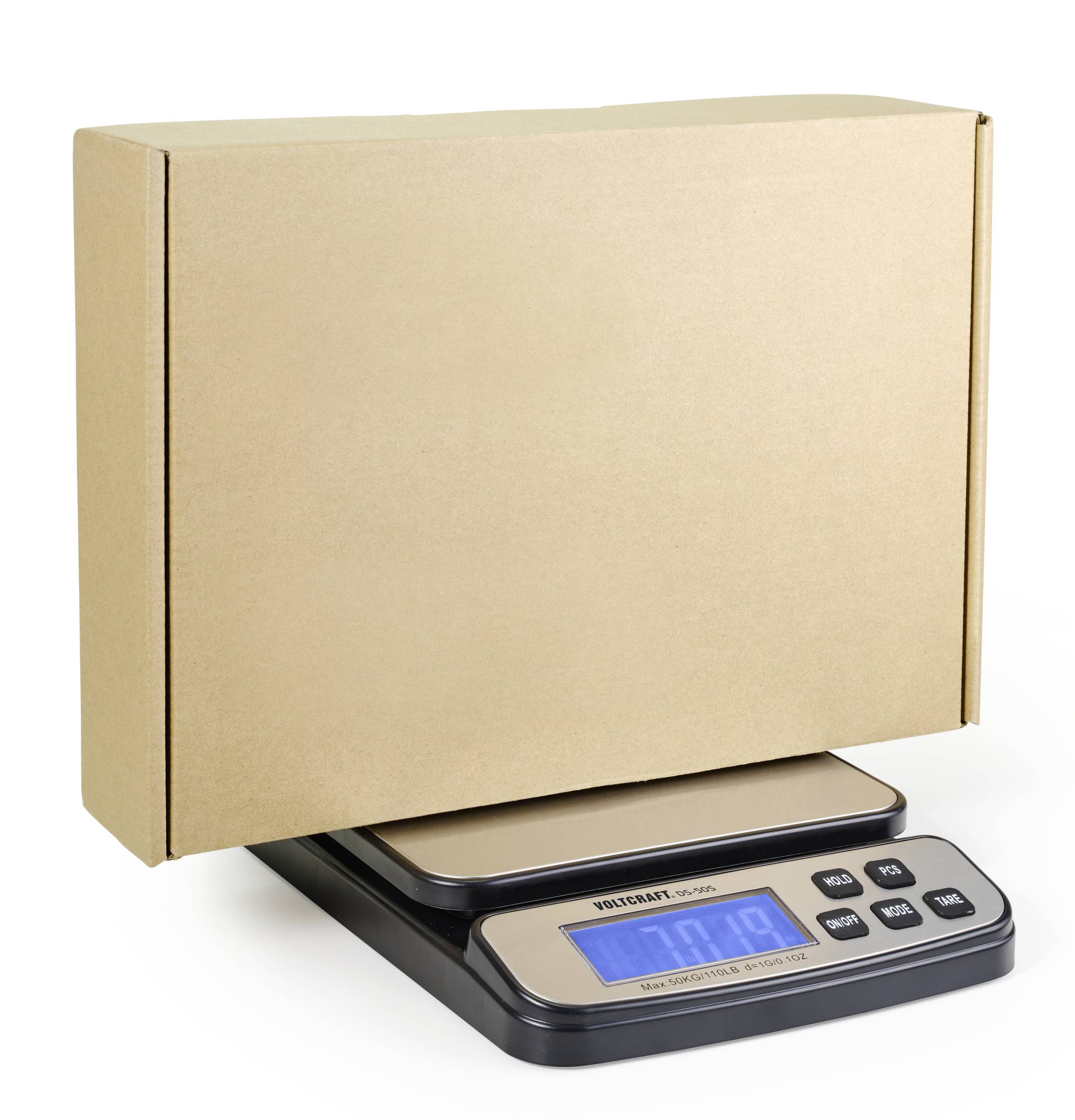 A digital scale displays 7.9 kg while weighing a large, sealed, brown cardboard box.