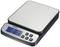 Digital kitchen scales with a blue-illuminated display showing '0.1 g'. It has several buttons: Hold, PCS, On/Off, Mode, Tare.
