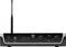 A black audio transmitter with an antenna, digital channel display, LED indicators, two rotary knobs for volume on the left and right.