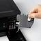A person replaces the ink cartridge in a printer by removing an empty cartridge from the opened printer flap.