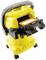 A yellow vacuum cleaner with a removable filter and a black carrying handle, standing on four wheels, for cleaning purposes.