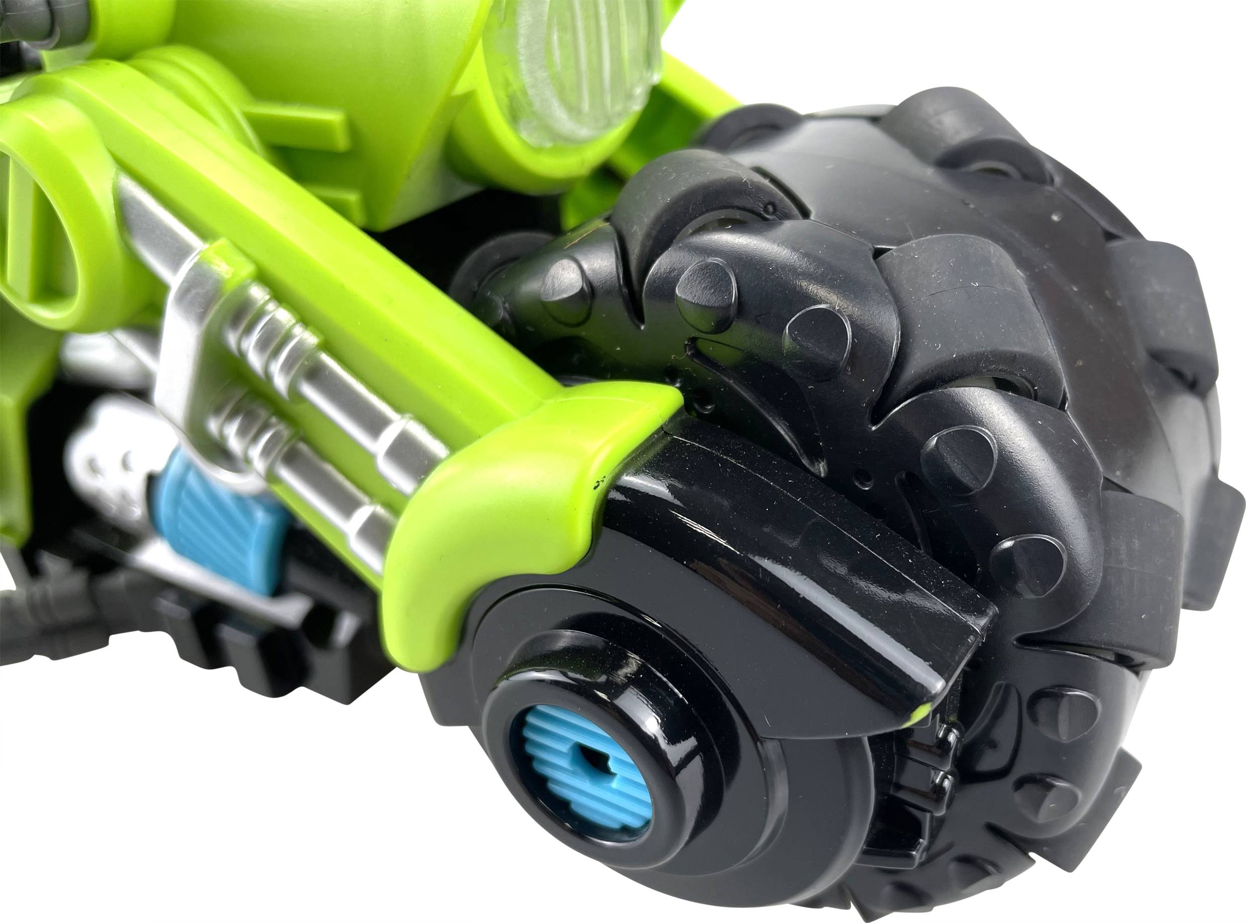 Close-up of a green and black toy motorcycle wheel with striking details and a blue accent colour.