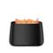 A black, rectangular humidifier with flame effect on the top, by Stadler Form. Perfect for modern interior design.