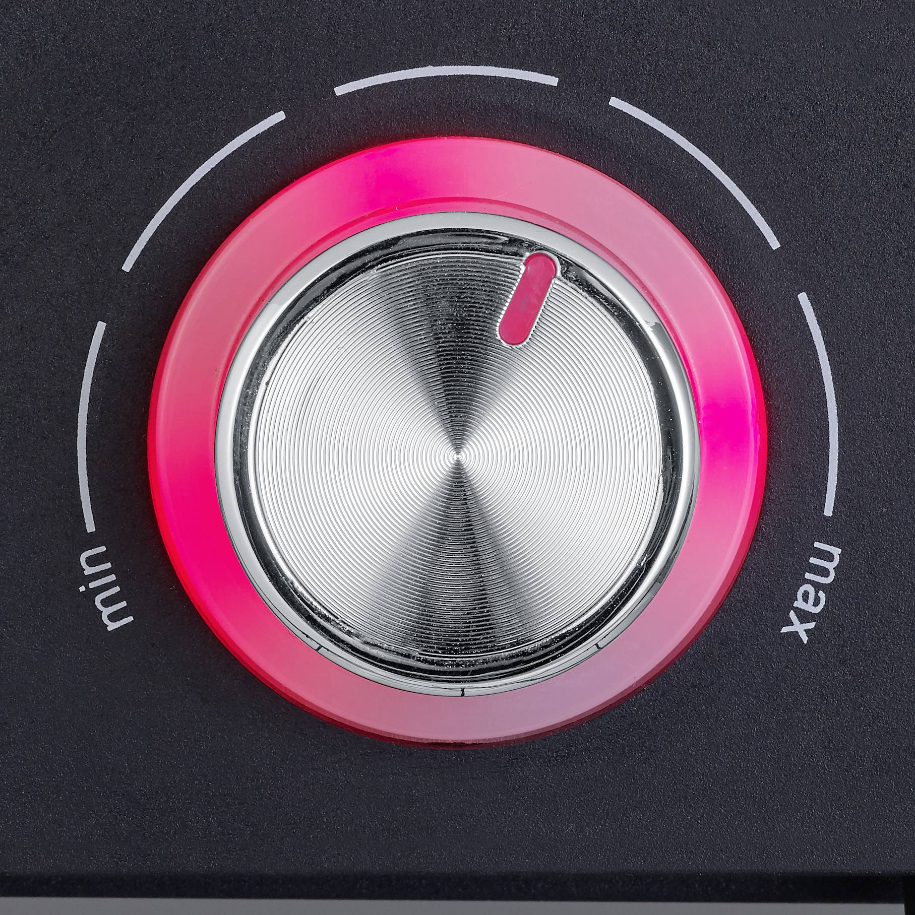 Rotary knob in close-up with red illumination, showing position between 'min' and 'max', used for volume control.
