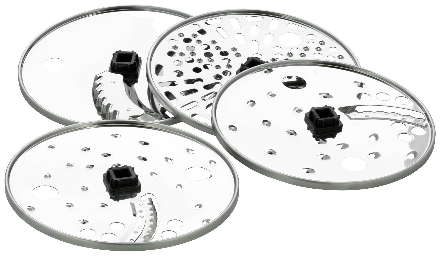 Four silver cutting discs with different hole patterns and serrations for food processors are laid side by side.