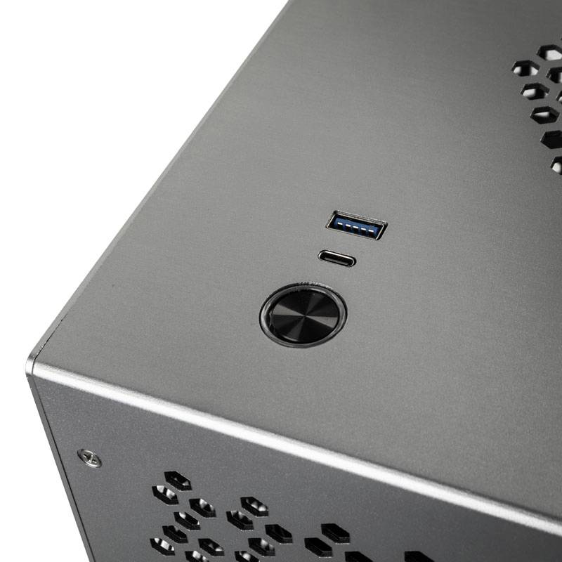 Metal computer casing with USB ports and ventilation slots on the top surface.