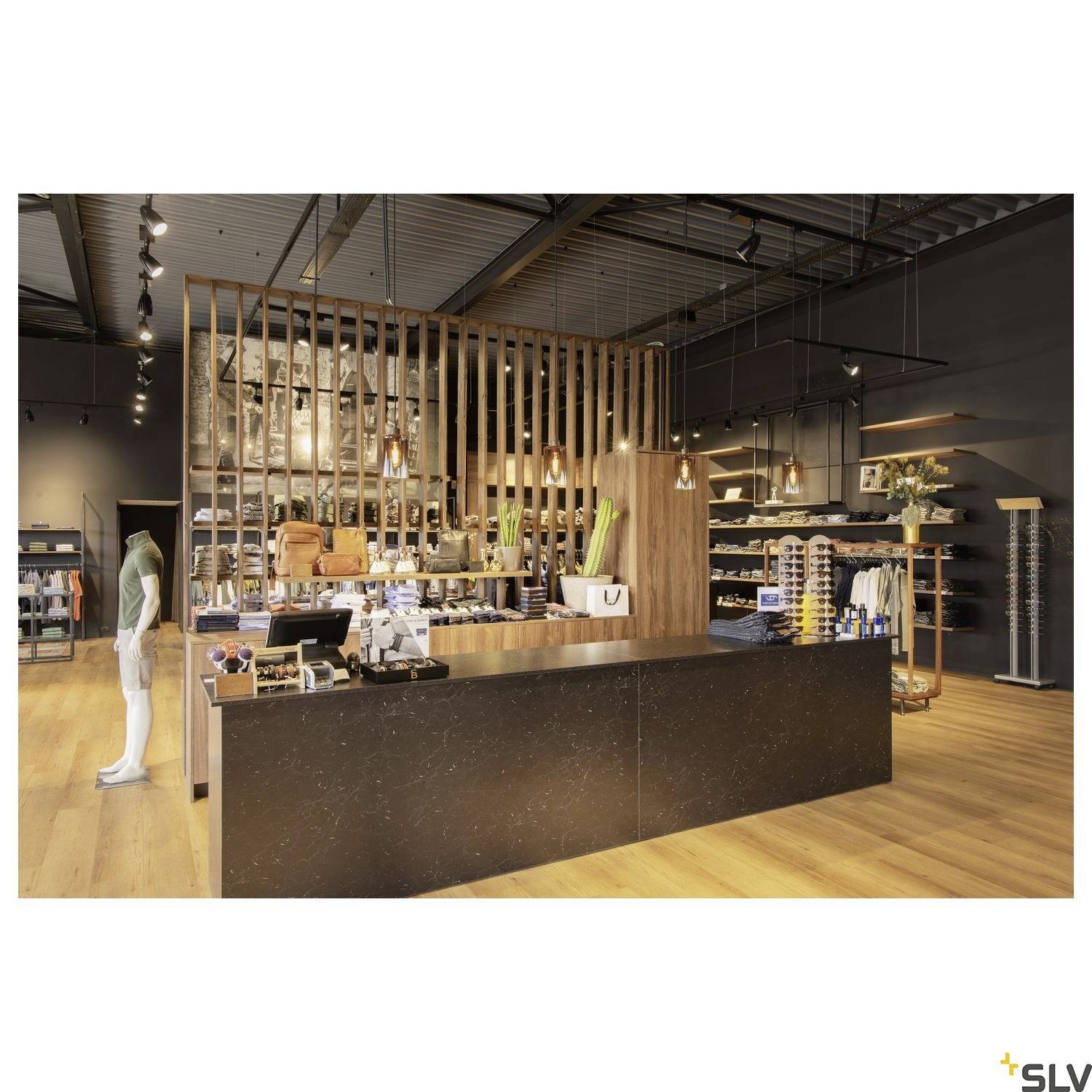 A modern retail shop with wooden panelling, stylish lighting, and fashion items on shelves. A counter in the foreground.