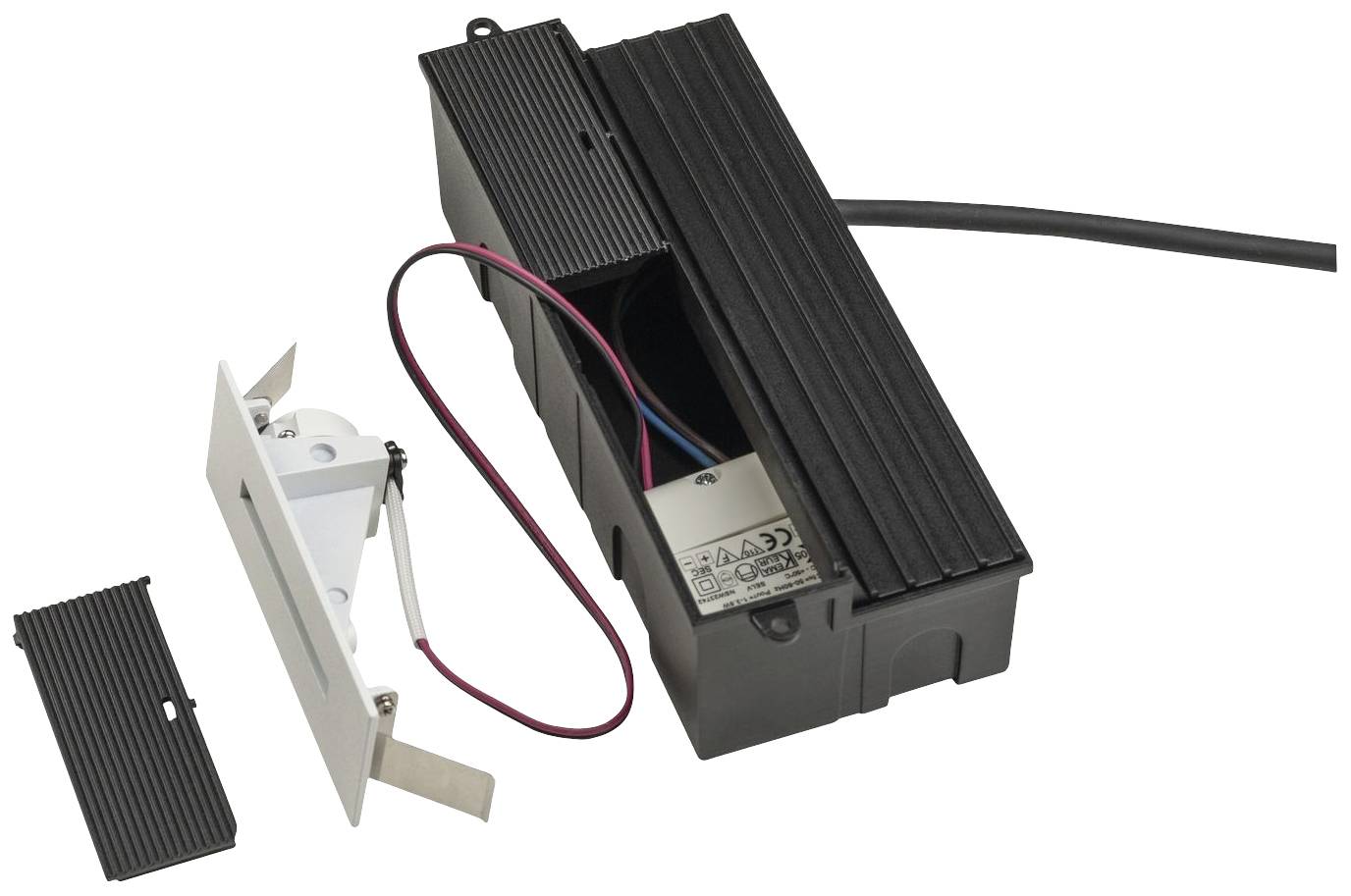 An electronic device with a black casing reveals red and blue wires. Two removable covers lie beside it.