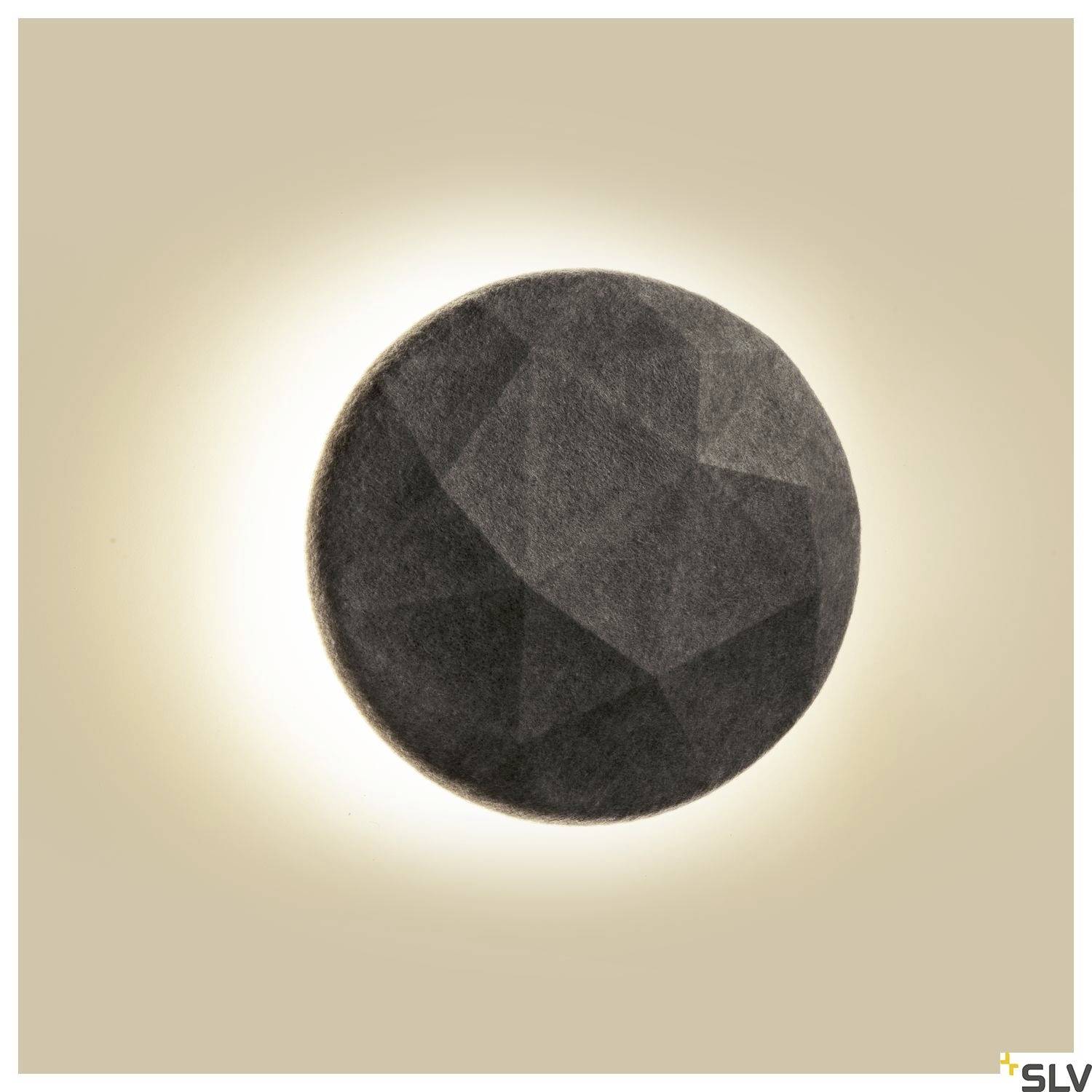 A round, dark wall light with a textured surface, creating a diffused, warm glow against a light background.