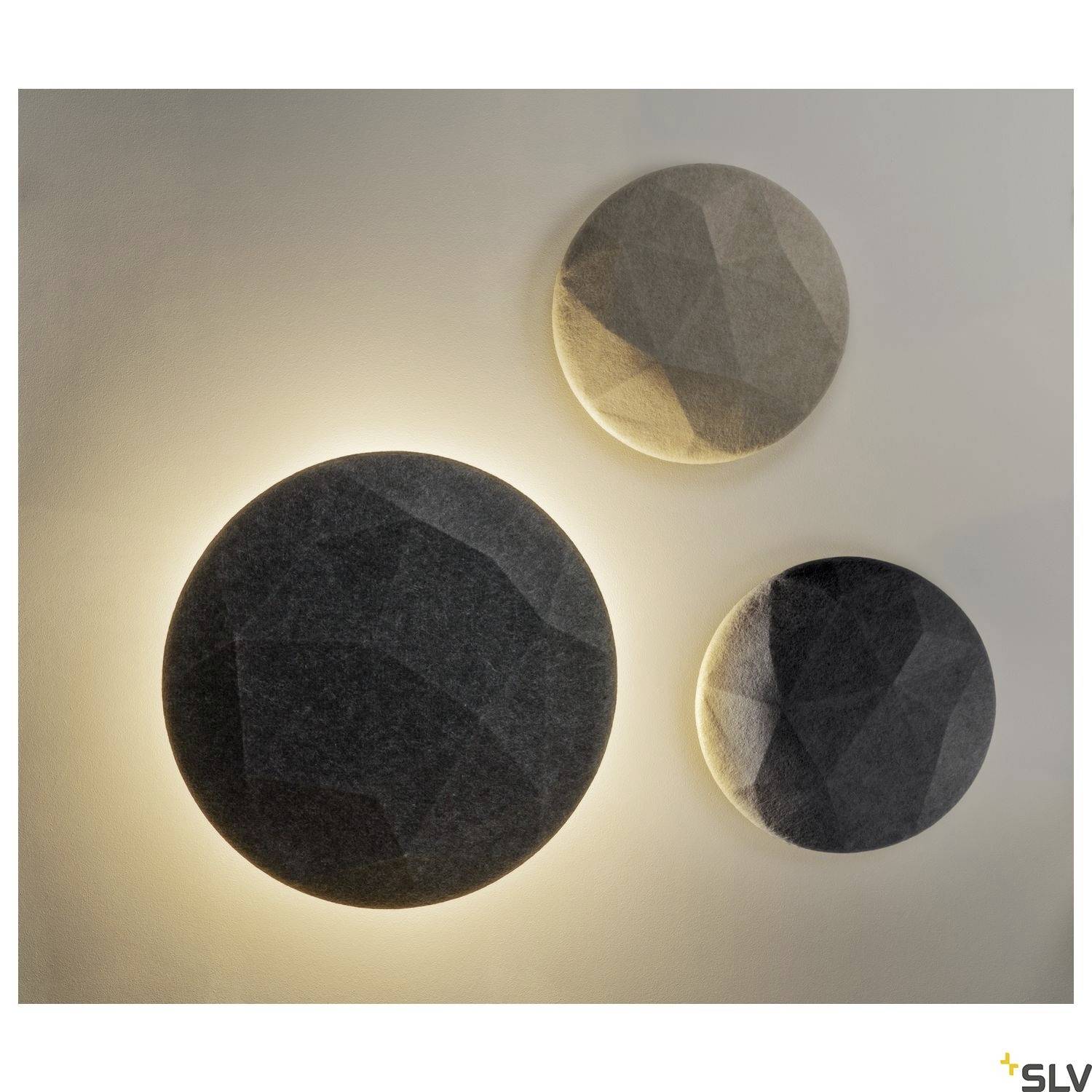 Three round, three-dimensional wall lights in different shades of grey with a geometric pattern illuminate from behind.