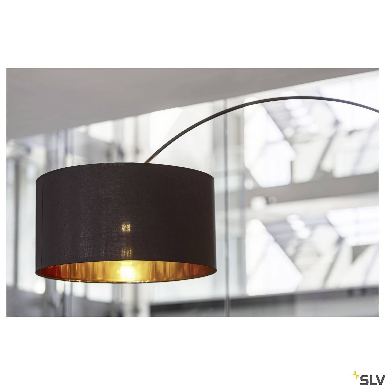 Modern, black pendant light with a golden interior coating, illuminating a bright, glass-enclosed space.