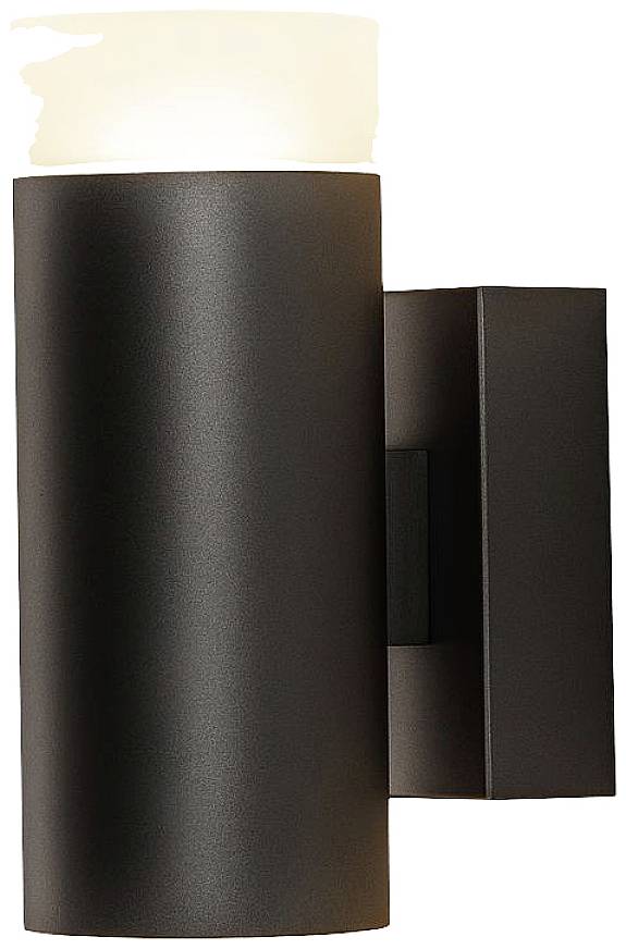Black, cylindrical wall lamp with a white diffuser that illuminates from the top. Suitable for modern interior spaces.