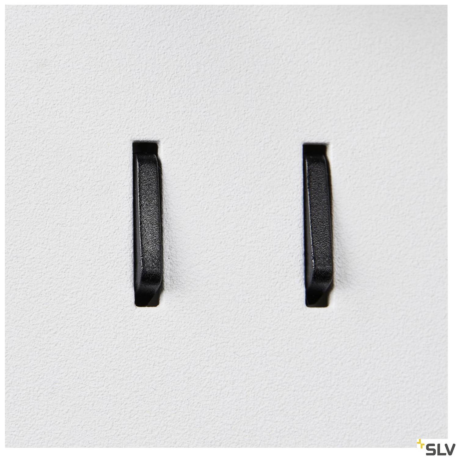 Two black switches on a white plate, possibly light switches in a modern design. Simple and functional design.