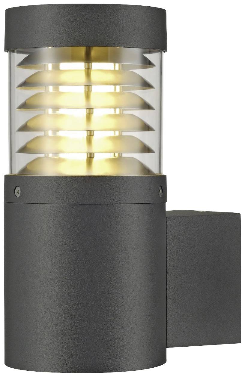 A contemporary wall light with a cylindrical design, black mounting bracket, and illuminated, ribbed glass, mounted laterally on the wall.