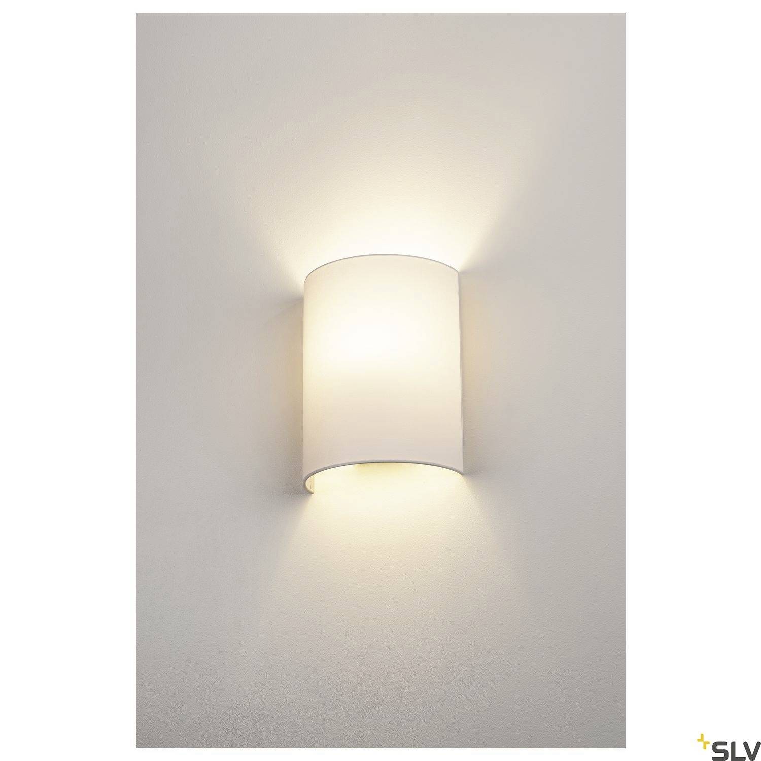 A contemporary, cylindrical wall light that emits soft, diffused light upwards and downwards, mounted on a neutral wall.