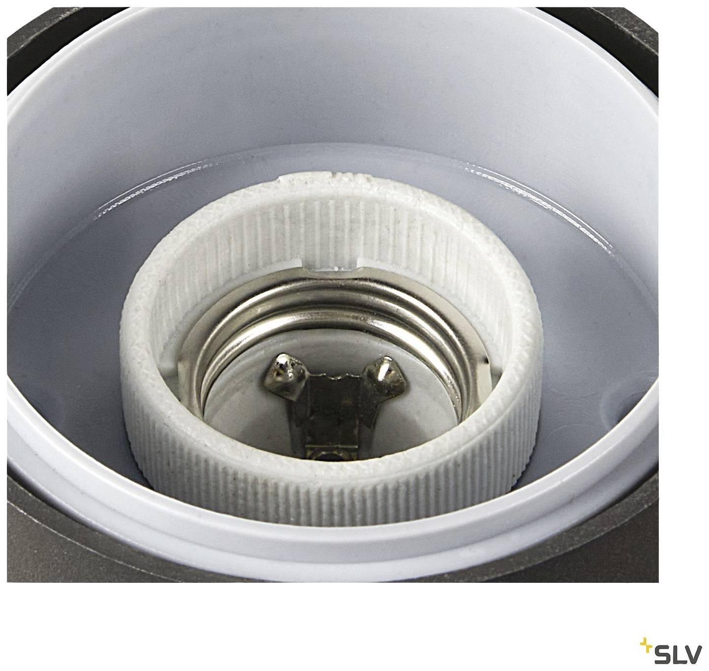 Close-up of an empty metal and ceramic lamp socket. The socket has a threaded fitting for connecting a light bulb.