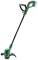 Green, cordless lawn trimmer with long handle, red operating button, and protective guard on the cutting head, ideal for small gardens.