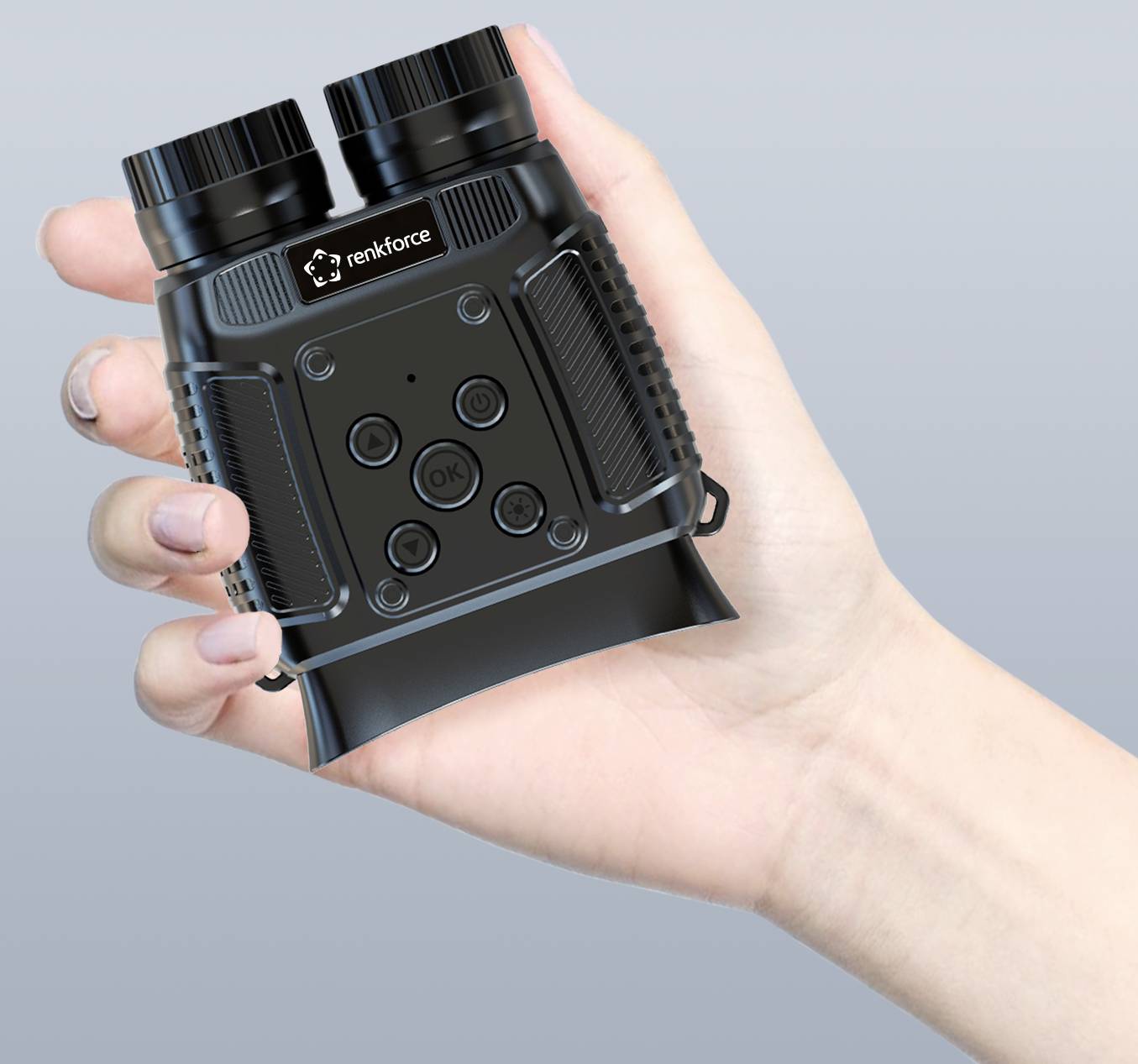 A hand holds a black, compact optical device with multiple buttons, suitable for outdoor observations or hunting.