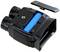 A portable device in black with its case open, revealing a blue battery inside. To the right, a removable cover is positioned.